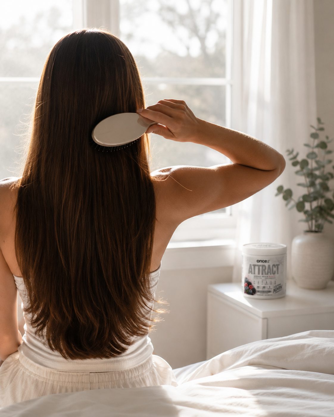 Brushing long healthy hair in morning light